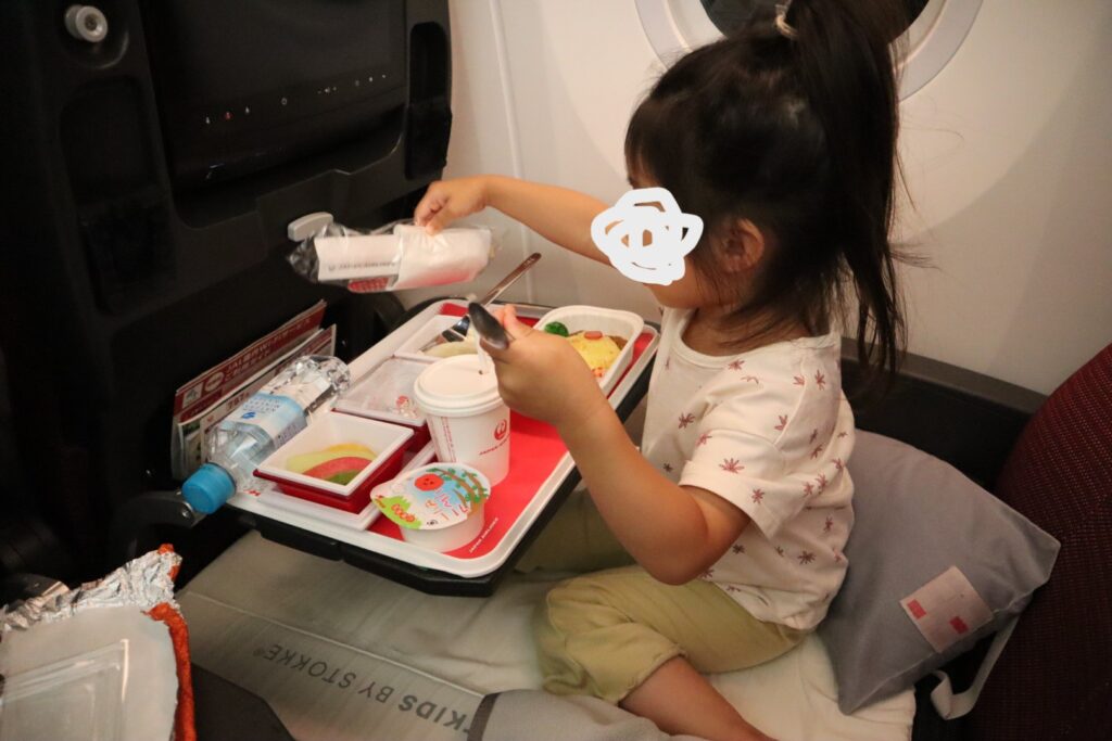 機内食を楽しむ娘の写真